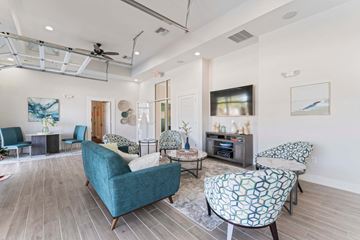 Jacksonville apartment for rent - A living room with a blue chair and a patterned chair.