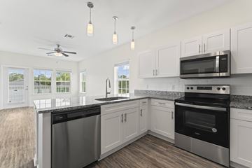 Atlantic Beach apartment for rent - A kitchen with a stainless steel dishwasher and oven, and a microwave above the stove.
