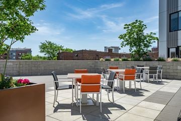 Bayonne apartment for rent - A patio with orange chairs and a table.