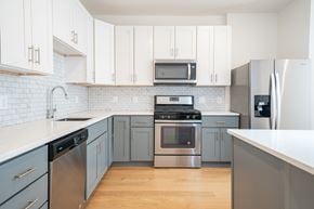 Bayonne apartment for rent - A kitchen with a stainless steel refrigerator and oven.