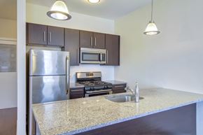 Stamford apartment for rent - Kitchen with stainless steel appliances and island at 750 Summer Street Apartments, Stamford