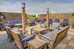 Stamford apartment for rent - Rooftop lounge with wooden furniture and privacy panels at 163 Franklin Street Apartments, Connecticut