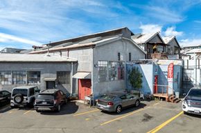Oakland apartment for rent - A parking lot with cars and a building in the background.