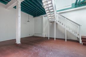 Oakland apartment for rent - A room with a white staircase and a green roof.