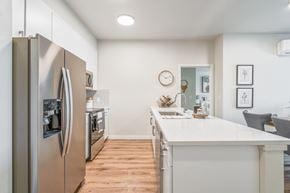 Portland apartment for rent - a kitchen with white quartz countertops and stainless steel appliances