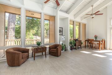 Plano apartment for rent - A living room with a brown chair and a brown table.