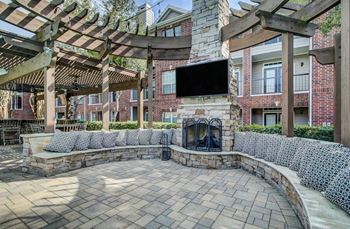 Outdoor patio with fireplace and seating