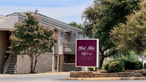 Plano apartment for rent - A sign for Bel Air Apartments stands in front of a building.
