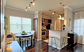 Dallas apartment for rent - A kitchen with a table and chairs in front of a window.