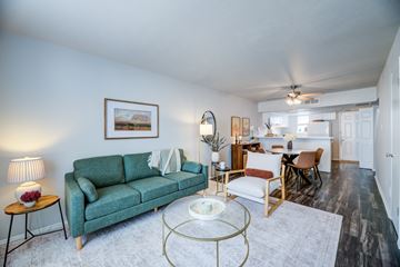 Plano apartment for rent - A living room with a green couch and a coffee table.