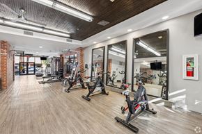 Plano apartment for rent - A gym with a row of stationary bikes.