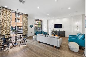 Plano apartment for rent - A modern living room with a white sofa and a television.