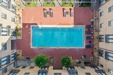 Plano apartment for rent - A rectangular pool in the middle of a courtyard surrounded by buildings.