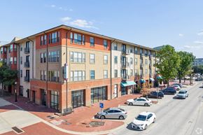 Plano apartment for rent - A street view of a residential area with cars parked on the side of the road.