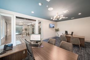 Houston apartment for rent - a conference room with a desktop computer on a wooden desk