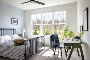 Morganville apartment for rent - a bedroom with a bed and a large window