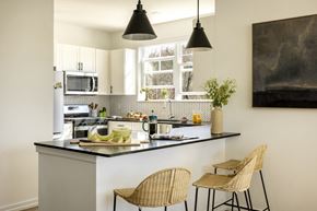 Morganville apartment for rent - a kitchen with a counter and three stools