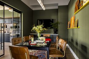 Morganville apartment for rent - a dining room with leather chairs and a table with a vase of flowers