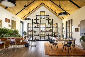 East Hanover apartment for rent - A modern dining room with a wooden ceiling and a large table surrounded by chairs.