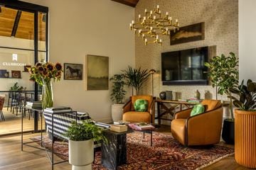 Hopewell Township apartment for rent - A living room with a striped sofa and a chandelier.
