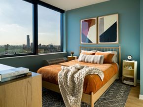 Jersey City apartment for rent - a bedroom with a bed and a large window