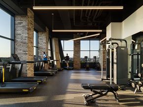 Jersey City apartment for rent - a gym with treadmills and weights on the floor and windows