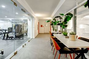 Montreal apartment for rent - a conference room with a table and chairs and a large plant