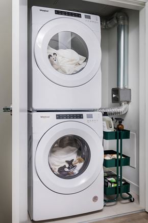 Vancouver apartment for rent - Two Whirlpool washing machines stacked on top of each other in a laundry room.
