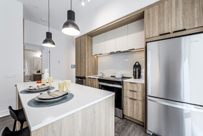 Mississauga apartment for rent - A modern kitchen with a dining table and chairs.
