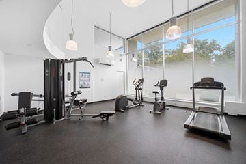 Burlington apartment for rent - A gym with a variety of equipment including treadmills, weights, and exercise machines.