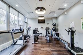Toronto apartment for rent - A gym with treadmills, exercise bikes, and weights.