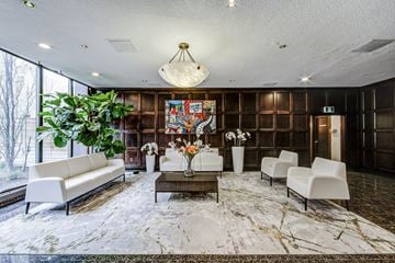 Toronto apartment for rent - A living room with a large rug and a painting on the wall.