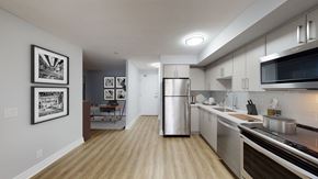 Toronto apartment for rent - an open kitchen and living room with a stainless steel refrigerator