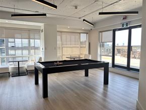 Toronto apartment for rent - A pool table in a room with a view of the outside.