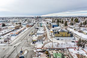 Calgary apartment for rent - A view of a city with roads, buildings, and a snowy landscape.