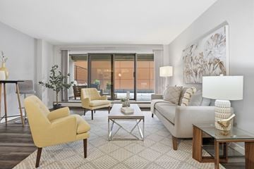 Edmonton apartment for rent - A living room with a yellow chair and a white couch.