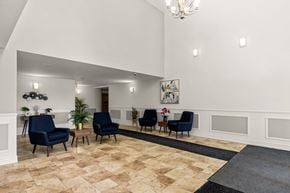 Dartmouth apartment for rent - A room with a chandelier, a painting, and a row of chairs.