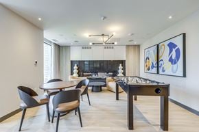 Mississauga apartment for rent - A modern dining room with a pool table and a fireplace.