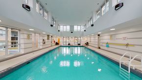 Toronto apartment for rent - A large indoor swimming pool with a blue tiled bottom at Vivere.