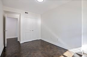 Toronto apartment for rent - A bedroom with closet at a bathroom with a toilet and a sink and a mirror at A shower with a glass door at 50 Prince Arthur