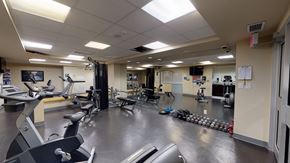 Toronto apartment for rent - a fitness center with cardio machines and weights