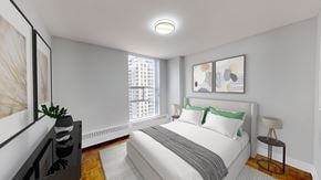 Toronto apartment for rent - A bedroom with a large bed, a window, and a painting on the wall.