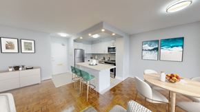 Toronto apartment for rent - A modern kitchen with a dining table and chairs.