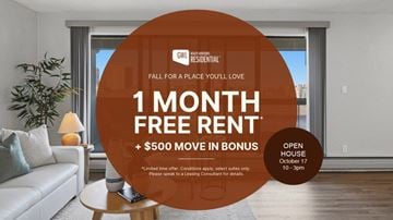 Edmonton apartment for rent - A living room with a couch and a sign offering free rent and a bonus.