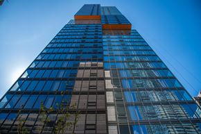 Toronto apartment for rent - A tall building with a blue sky in the background.