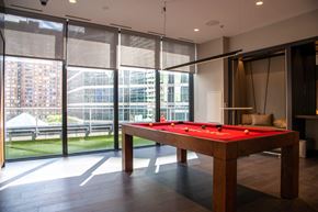 Toronto apartment for rent - A pool table in a room with a view of the outside.