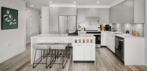 Vancouver apartment for rent - A modern kitchen with white cabinets and a large island.