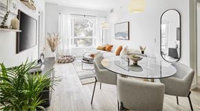 Vancouver apartment for rent - A modern dining room with a glass table and grey chairs.