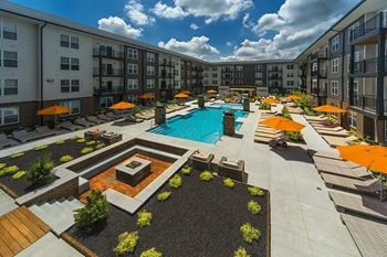 An aerial view of an apartment complex with a swimming pool