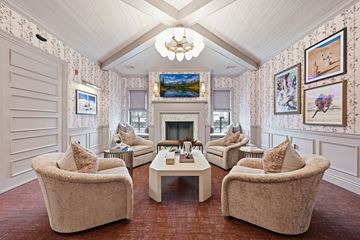 Columbus apartment for rent - A living room with a fireplace and a painting of a beach scene on the wall.
